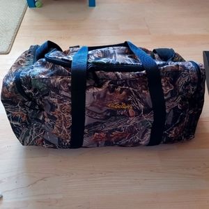 Cabelas Seclusion 3D large camo duffel with 2 end zip pockets.